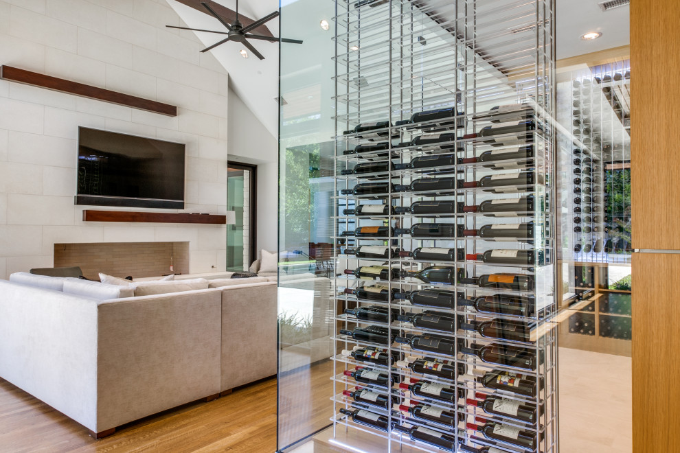 Example of a minimalist wine cellar design in Dallas with storage racks
