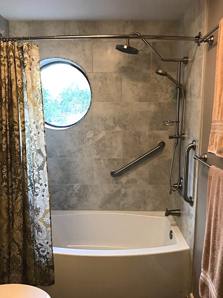 Photo of a small classic family bathroom in Seattle with freestanding cabinets, medium wood cabinets, an alcove bath, a shower/bath combination, a one-piece toilet, grey tiles, porcelain tiles, blue walls, porcelain flooring, a built-in sink and granite worktops.