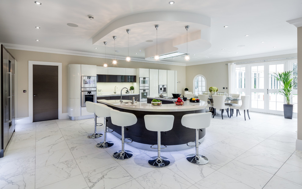 Inspiration for a contemporary galley eat-in kitchen in Berkshire with flat-panel cabinets, black cabinets, white splashback, stainless steel appliances, with island and white floor.