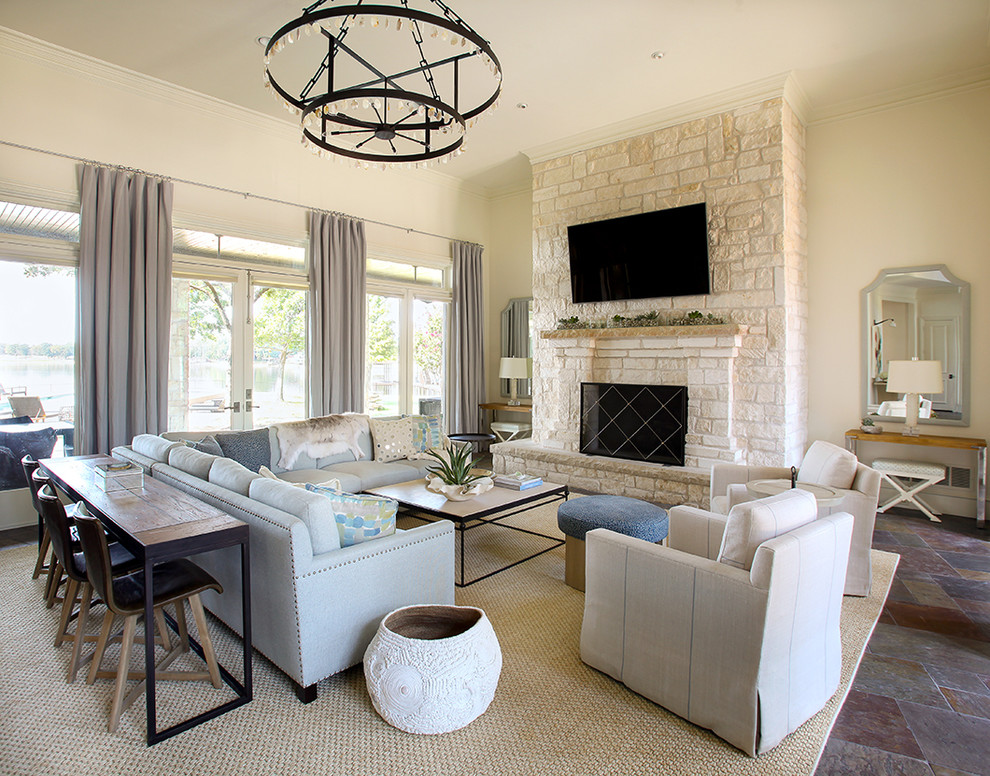Mid-sized transitional formal enclosed living room in Dallas with beige walls, a standard fireplace, a stone fireplace surround, a wall-mounted tv and slate floors.