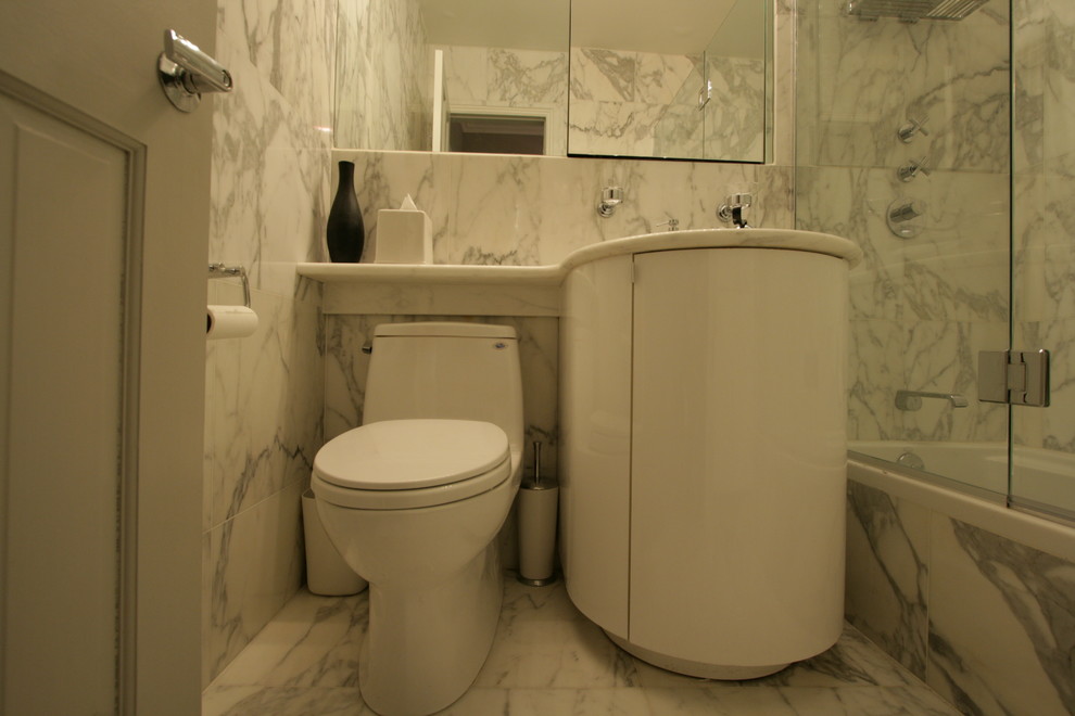 Small contemporary bathroom in New York with an undermount sink, flat-panel cabinets, marble benchtops, an alcove shower, white tile, stone tile, marble floors and an alcove tub.