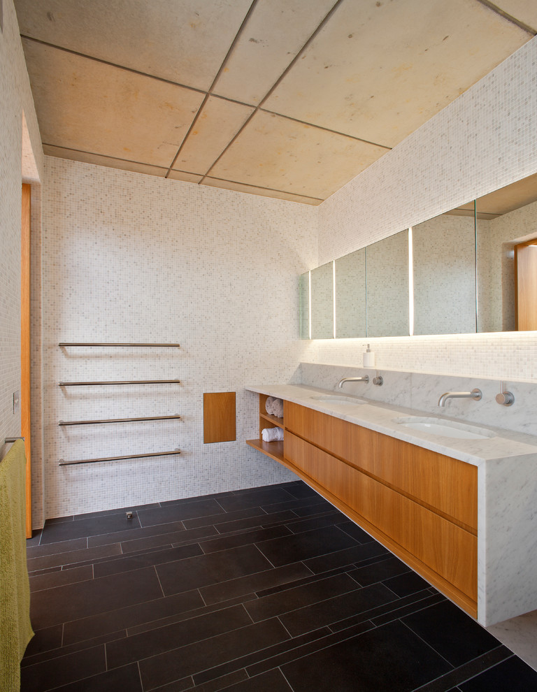 Mid-sized contemporary master bathroom in Sydney with an undermount sink, flat-panel cabinets, medium wood cabinets, marble benchtops, an alcove shower, a wall-mount toilet, gray tile, white walls and slate floors.