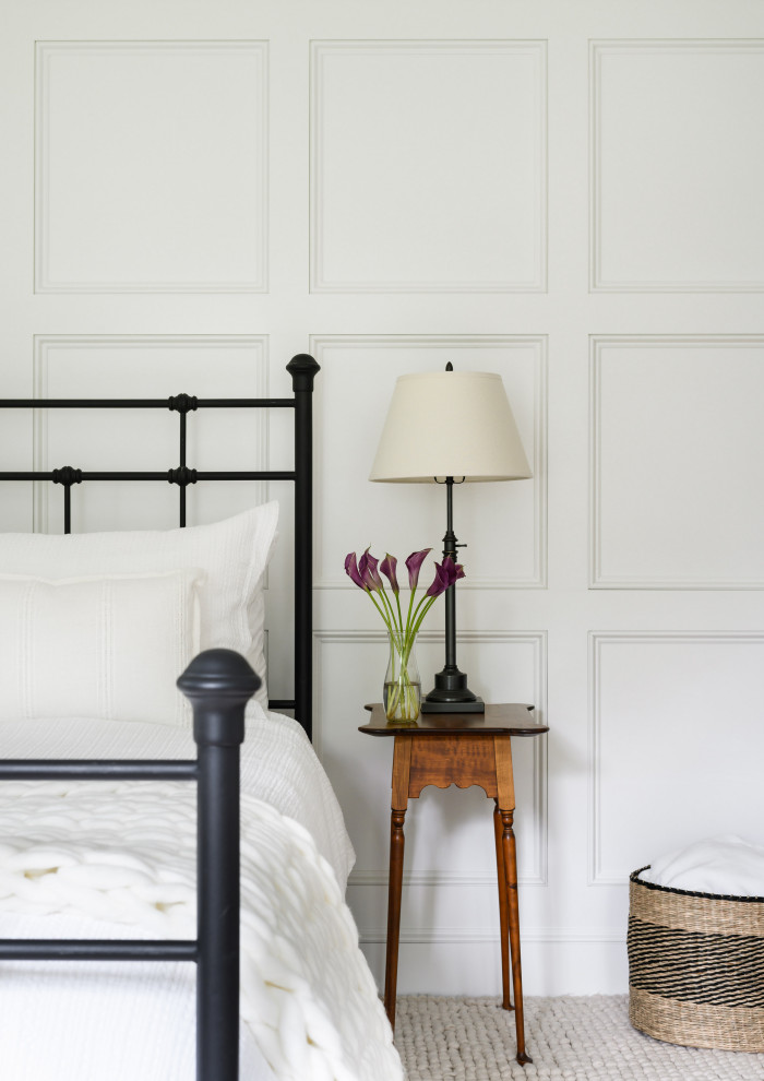 Design ideas for a country guest bedroom in Boston with medium hardwood floors and panelled walls.