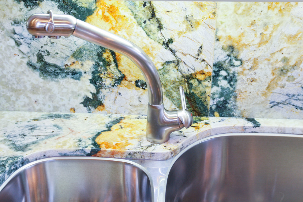 Inspiration for a large transitional galley ceramic tile eat-in kitchen remodel in Miami with a double-bowl sink, raised-panel cabinets, white cabinets, granite countertops, multicolored backsplash, stone slab backsplash, stainless steel appliances and an island