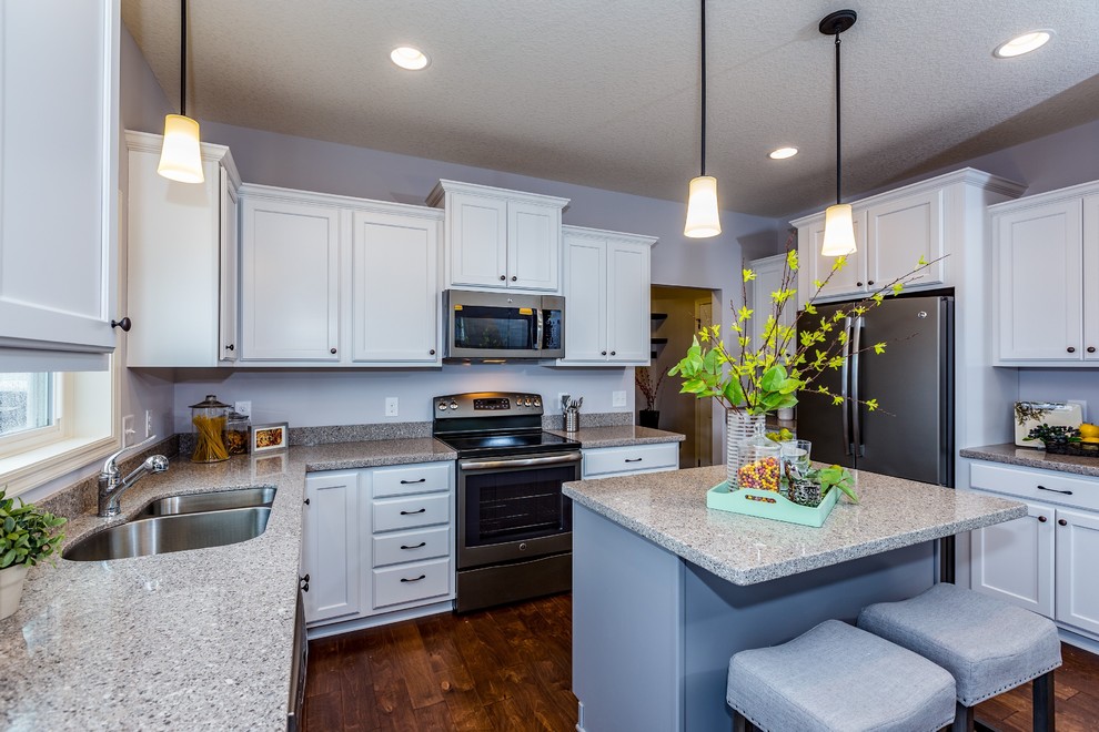 Eat-in kitchen - mid-sized transitional u-shaped medium tone wood floor eat-in kitchen idea in Minneapolis with an undermount sink, flat-panel cabinets, white cabinets, stainless steel appliances, an island and quartz countertops
