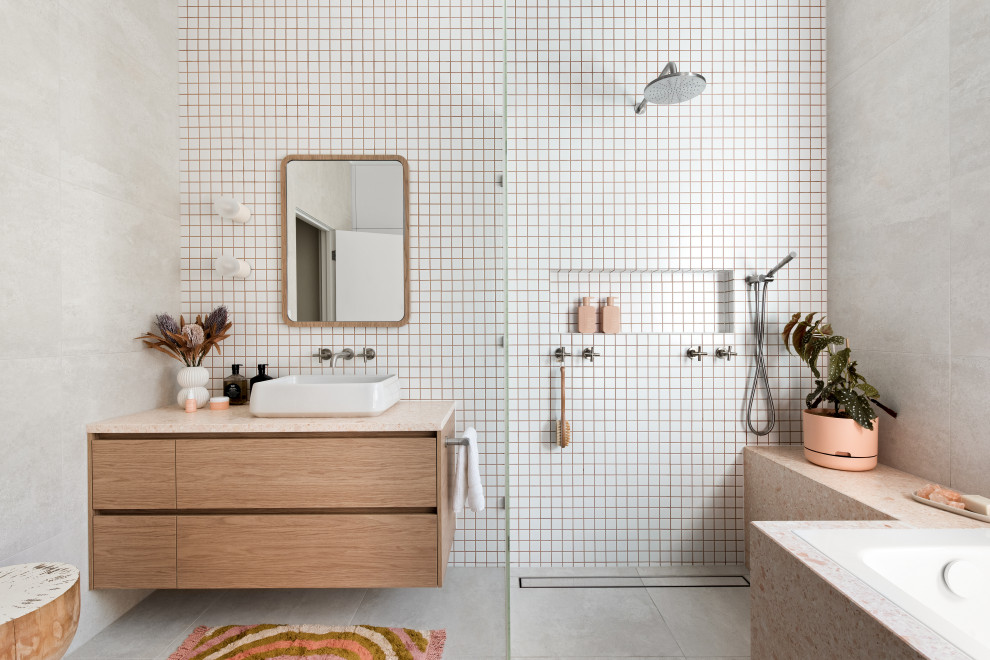 Design ideas for a mid-sized contemporary bathroom in Melbourne with medium wood cabinets, a corner tub, an open shower, white tile, terrazzo benchtops, an open shower, pink benchtops, an enclosed toilet, a single vanity, a floating vanity, flat-panel cabinets, a vessel sink and grey floor.