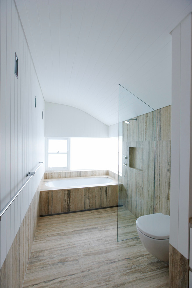 Large contemporary bathroom in Sydney with an undermount tub, an open shower and a wall-mount toilet.