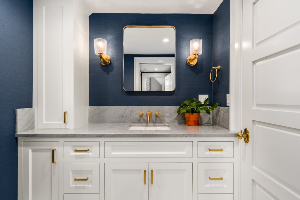 Inspiration for a small transitional bathroom in New York with recessed-panel cabinets, white cabinets, blue walls, an undermount sink, grey benchtops, a corner shower, a two-piece toilet, mosaic tile floors, marble benchtops, blue floor and a hinged shower door.