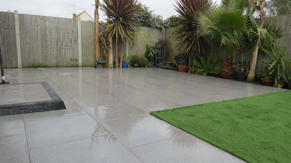 Porcelain/ Vitrified paved patio, paths with an artificial grass area