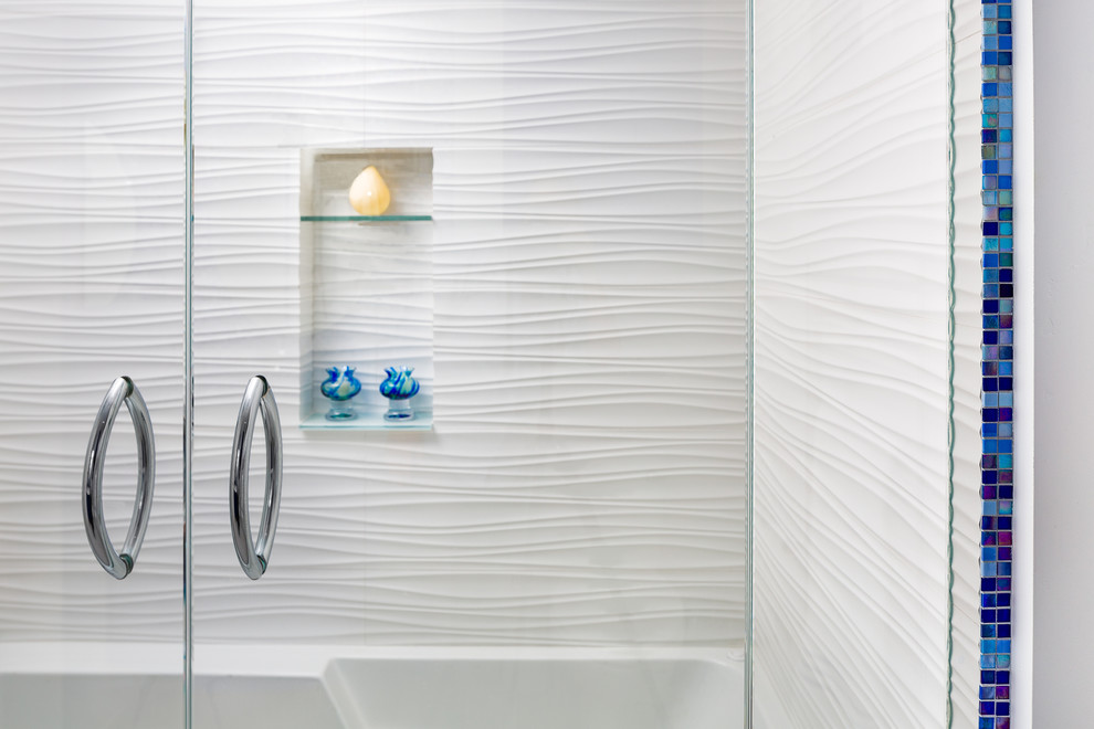 Mid-sized beach style bathroom in Other with blue cabinets, an alcove tub, a shower/bathtub combo, a one-piece toilet, blue tile, glass tile, white walls, ceramic floors, an undermount sink and engineered quartz benchtops.