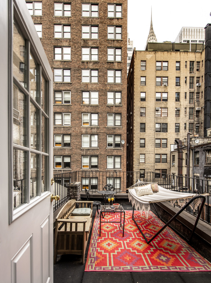 Design ideas for an eclectic balcony in New York with no cover and metal railing.