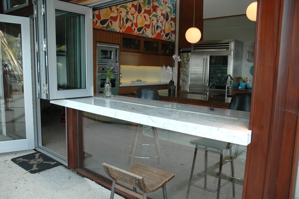 Inspiration for a midcentury kitchen in Santa Barbara with marble benchtops and stainless steel appliances.