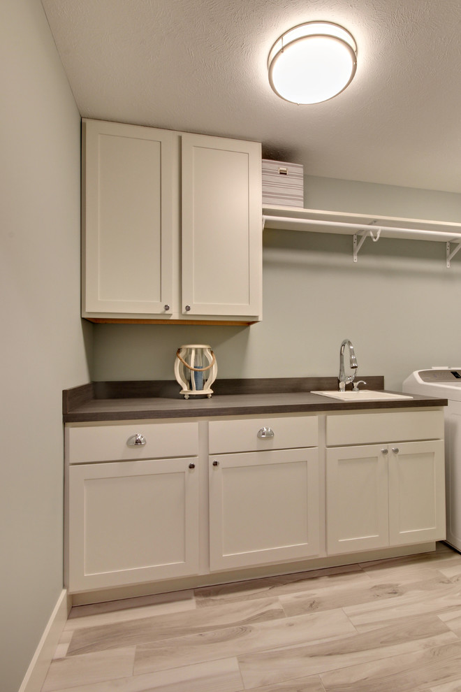 Beach style laundry room in Grand Rapids.