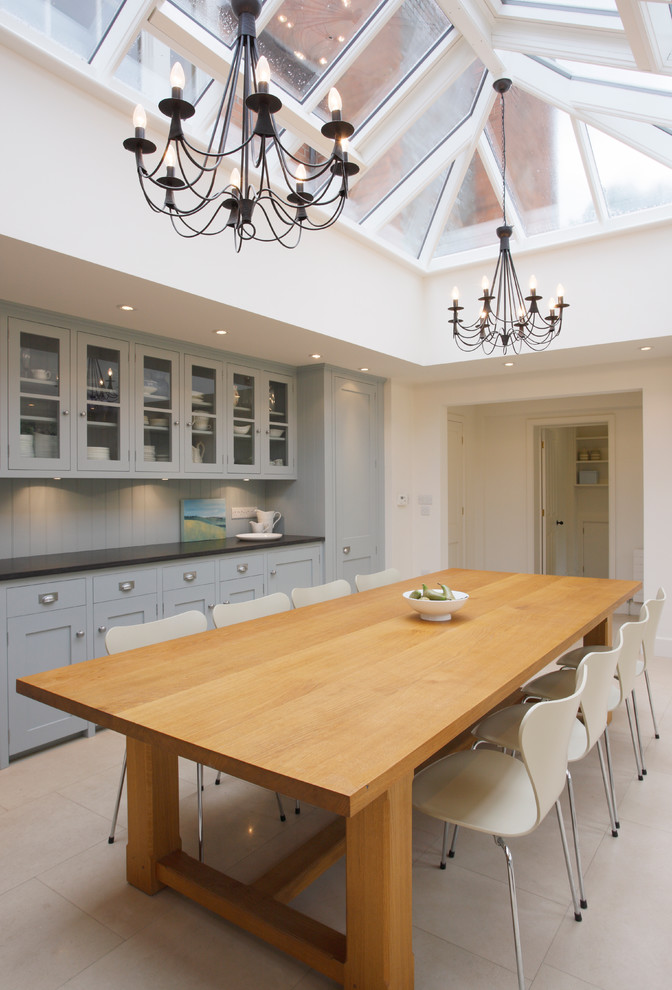 Design ideas for a large traditional kitchen/dining combo in London with white walls and limestone floors.