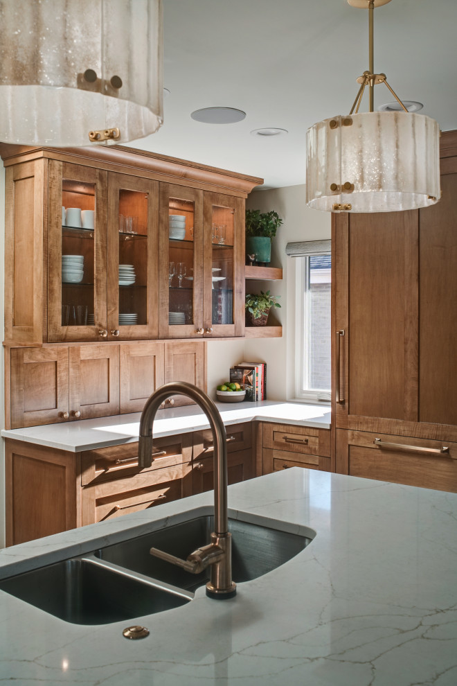 Inspiration for a mid-sized transitional l-shaped medium tone wood floor and brown floor open concept kitchen remodel in Chicago with an undermount sink, shaker cabinets, medium tone wood cabinets, quartz countertops, white backsplash, ceramic backsplash, stainless steel appliances, an island and white countertops