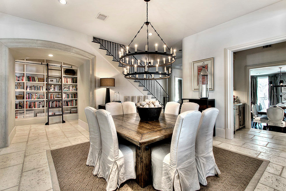 This is an example of a traditional dining room in Houston with white walls.