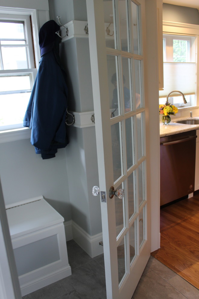 Small traditional mudroom in Boston with blue walls, porcelain floors, a single front door, a white front door and grey floor.