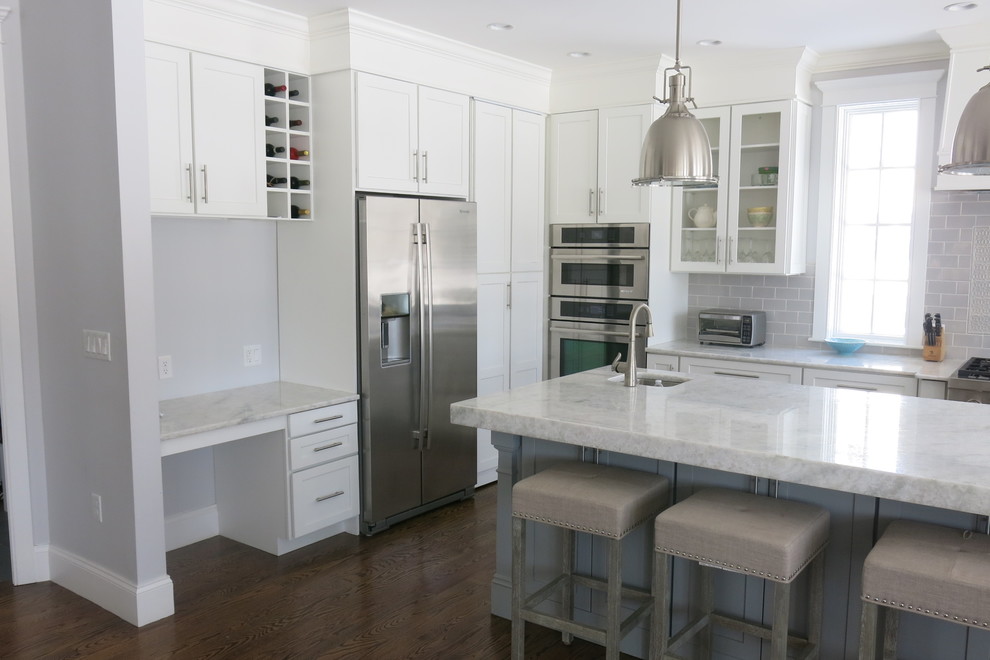 Inspiration for a mid-sized transitional u-shaped dark wood floor open concept kitchen remodel with shaker cabinets, white cabinets, quartzite countertops, gray backsplash, ceramic backsplash, stainless steel appliances, an island and white countertops