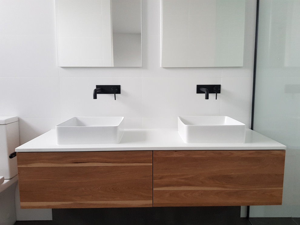 Inspiration for a large contemporary master bathroom in Melbourne with flat-panel cabinets, medium wood cabinets, white tile, ceramic tile, a pedestal sink, engineered quartz benchtops, white benchtops, a double vanity and a built-in vanity.