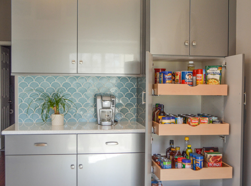 Enclosed kitchen - mid-sized transitional u-shaped porcelain tile and gray floor enclosed kitchen idea in Cleveland with an undermount sink, flat-panel cabinets, gray cabinets, quartz countertops, blue backsplash, ceramic backsplash, stainless steel appliances, no island and white countertops