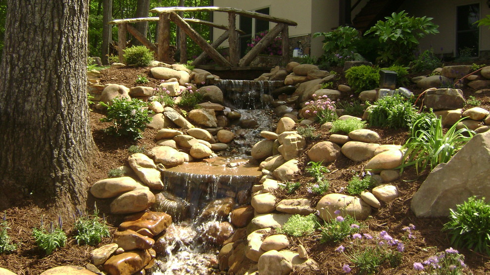 Design ideas for a country garden in Charlotte with a water feature.