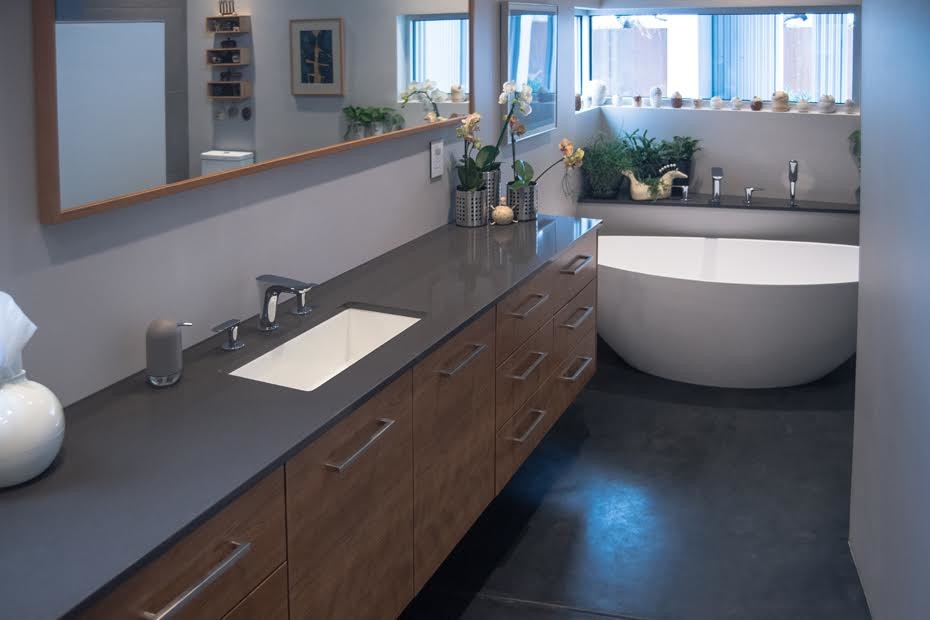 Inspiration for a mid-sized contemporary master bathroom in Phoenix with flat-panel cabinets, medium wood cabinets, a freestanding tub, beige walls, concrete floors, an undermount sink, engineered quartz benchtops and grey floor.
