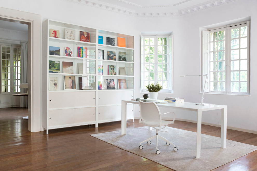 Inspiration for a mid-sized transitional study room in Other with white walls, medium hardwood floors, no fireplace and a freestanding desk.