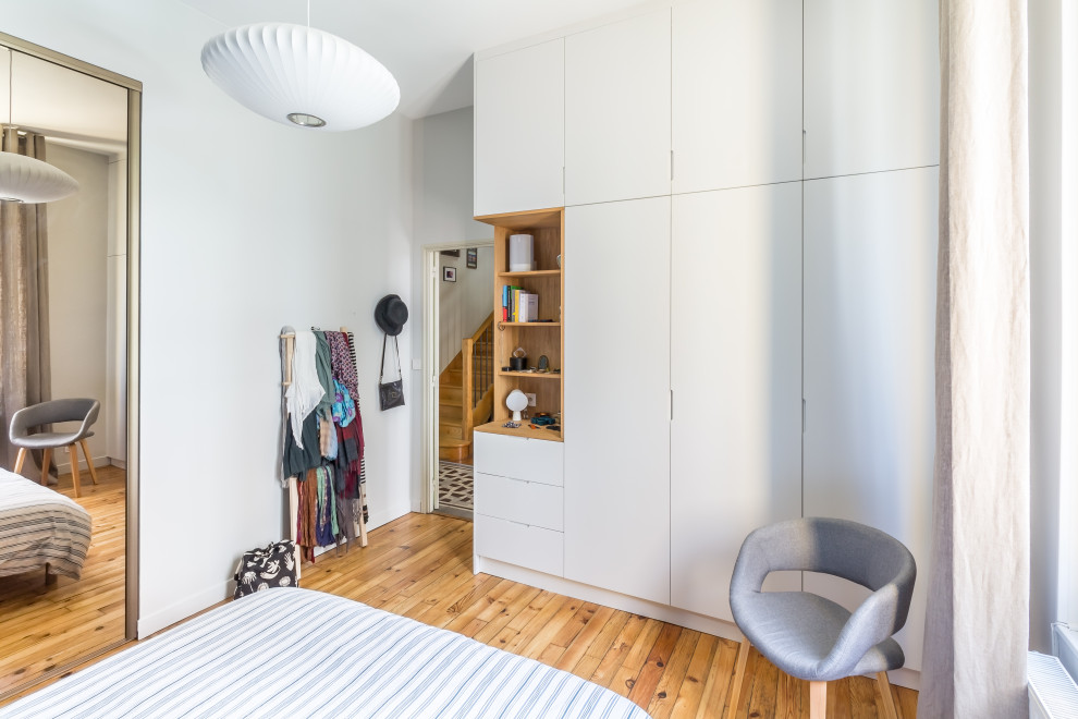 Foto de dormitorio blanco y madera ecléctico con paredes grises y suelo de madera en tonos medios
