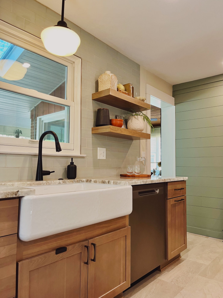 Eat-in kitchen - mid-sized transitional l-shaped vinyl floor and beige floor eat-in kitchen idea with a farmhouse sink, shaker cabinets, medium tone wood cabinets, quartzite countertops, green backsplash, ceramic backsplash, stainless steel appliances, no island and beige countertops