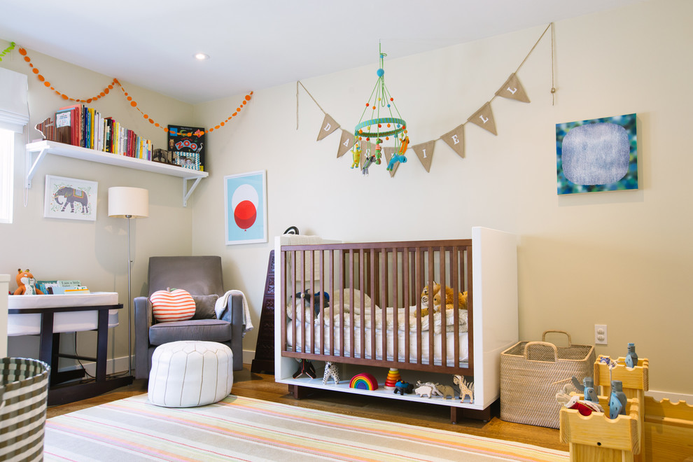 Inspiration for a contemporary gender-neutral nursery in San Francisco with beige walls and light hardwood floors.