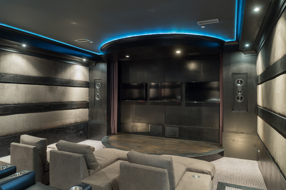 This is an example of a large contemporary enclosed home theatre in Atlanta with multi-coloured walls, carpet and a wall-mounted tv.