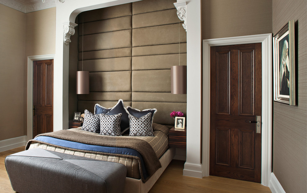 This is an example of a traditional bedroom in London with brown walls.