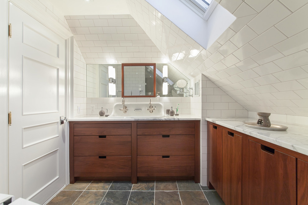 Photo of a transitional bathroom in Boston with a trough sink, flat-panel cabinets, dark wood cabinets, white tile and subway tile.