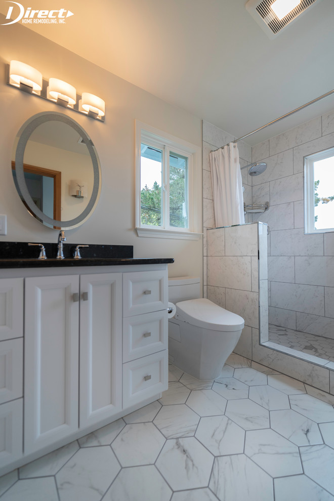 Large modern master bathroom in San Francisco with recessed-panel cabinets, white cabinets, an undermount tub, a double shower, a bidet, white tile, stone tile, white walls, marble floors, an undermount sink, granite benchtops, white floor, a shower curtain and black benchtops.