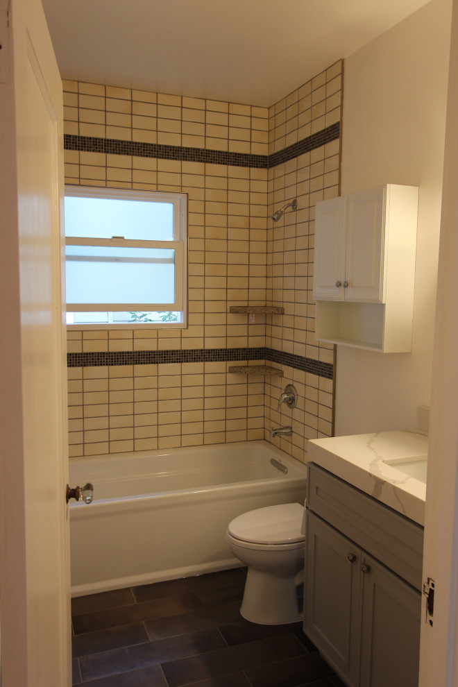 Photo of a small traditional bathroom in San Francisco with shaker cabinets, an alcove tub, a shower/bathtub combo, an undermount sink, quartzite benchtops, a single vanity, a freestanding vanity, grey cabinets, a one-piece toilet, subway tile, white walls, porcelain floors and a shower curtain.