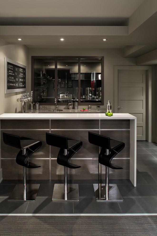 This is an example of a contemporary home bar in Ottawa with an undermount sink, grey floor and white benchtop.
