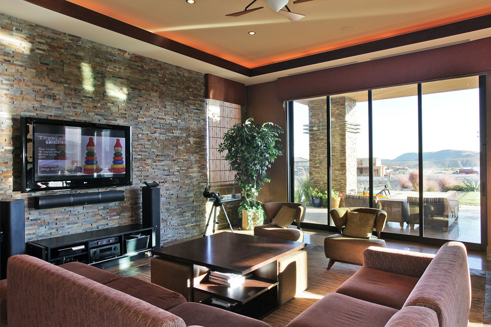 Inspiration for a contemporary family room in Las Vegas with brown walls and a wall-mounted tv.