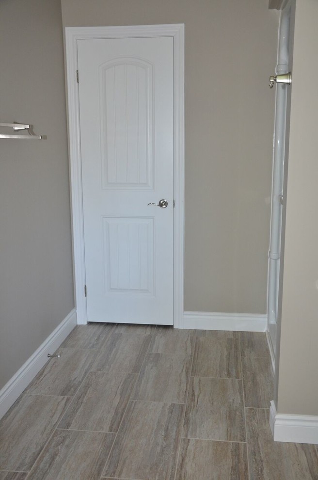 Inspiration for a mid-sized rustic master vinyl floor home design remodel in Calgary with shaker cabinets, light wood cabinets, a drop-in sink and laminate countertops