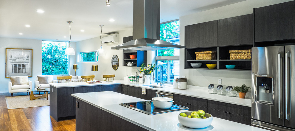 Open concept kitchen - modern l-shaped dark wood floor open concept kitchen idea in Seattle with an undermount sink, solid surface countertops, stainless steel appliances and an island