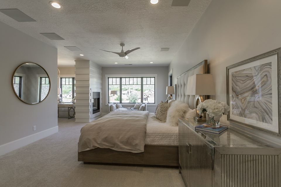 Inspiration for a large transitional master bedroom in Salt Lake City with grey walls, carpet, a two-sided fireplace, a wood fireplace surround and beige floor.