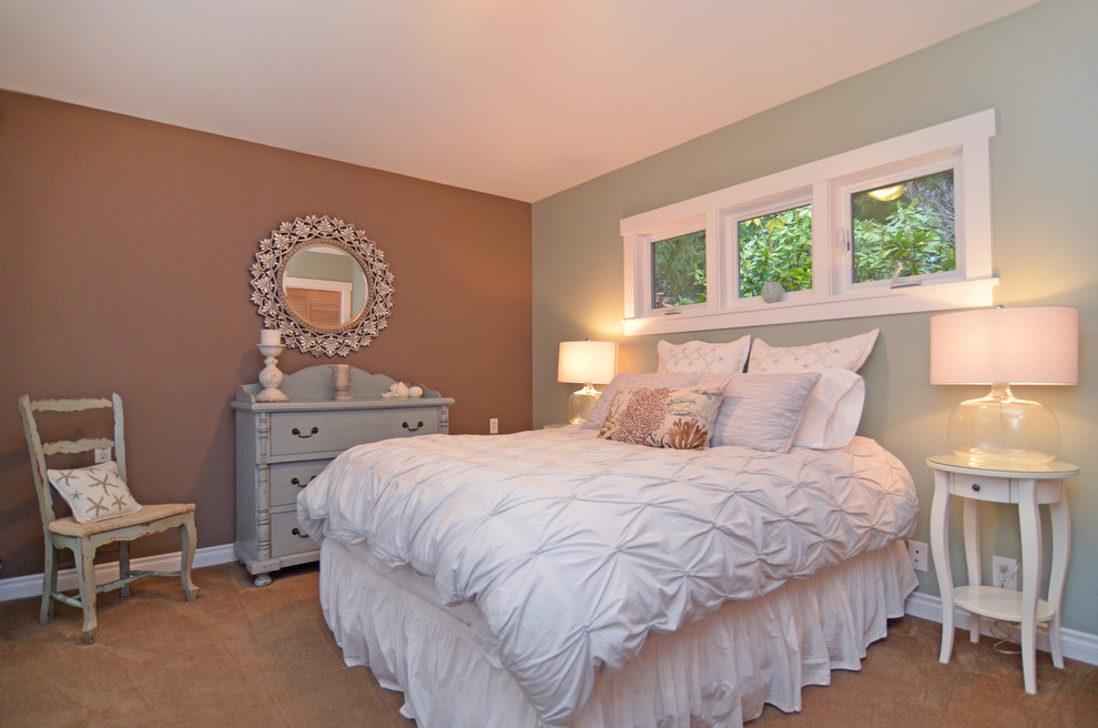 This is an example of a mid-sized beach style master bedroom in Seattle with carpet.