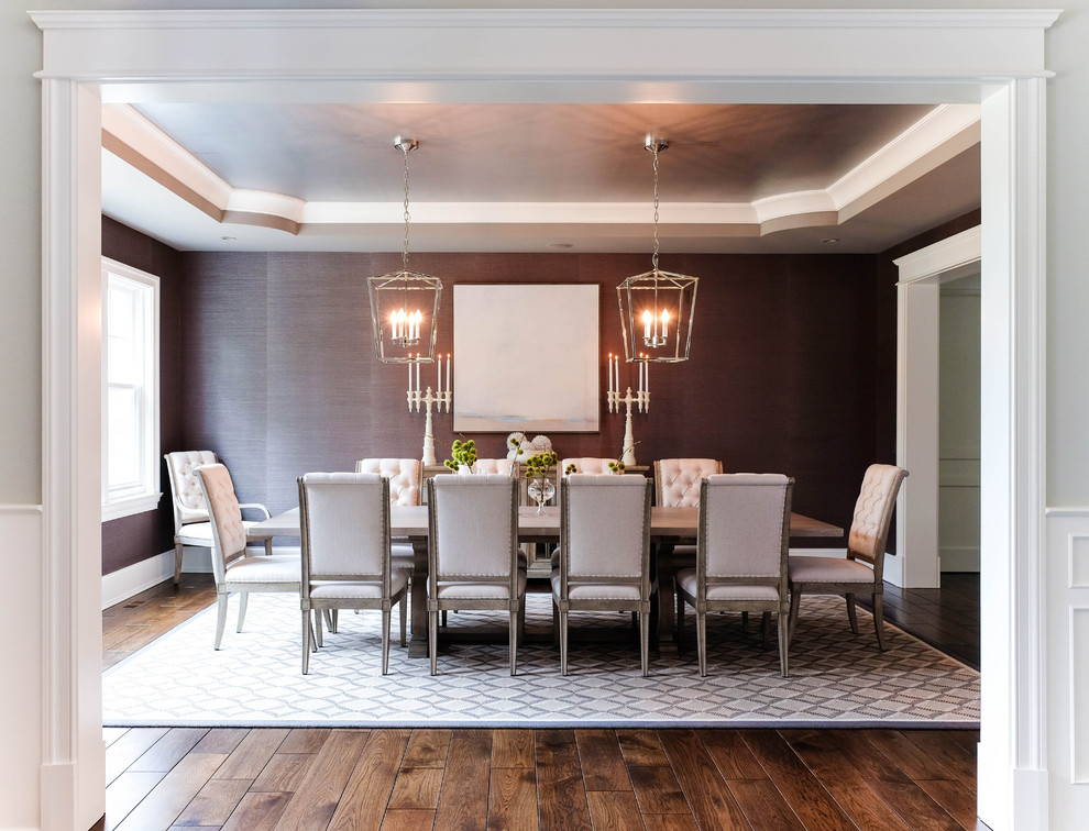 This is an example of a mid-sized transitional separate dining room in Chicago with red walls, dark hardwood floors, no fireplace and grey floor.