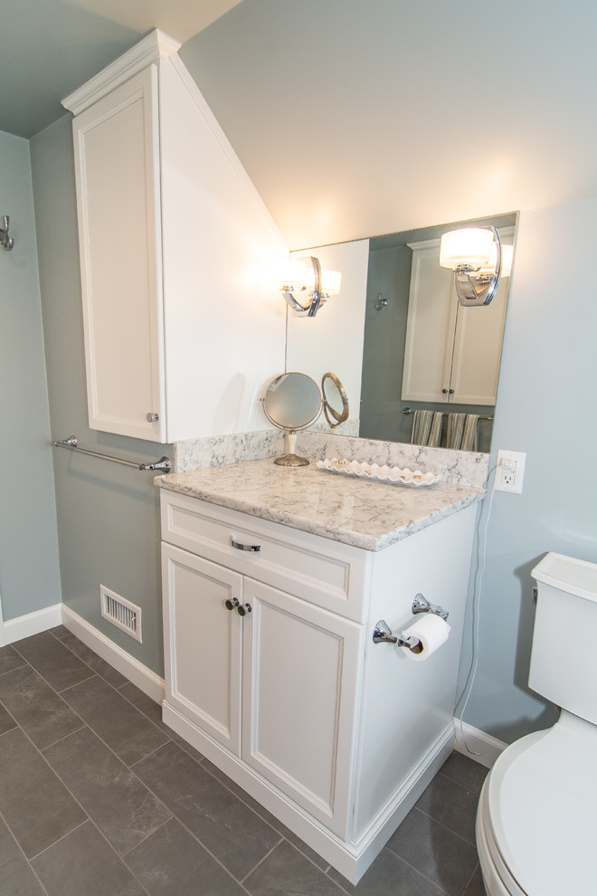 Mid-sized transitional master bathroom in Philadelphia with flat-panel cabinets, white cabinets, an alcove shower, a two-piece toilet, gray tile, porcelain tile, blue walls, porcelain floors, an undermount sink, engineered quartz benchtops, grey floor, a hinged shower door and white benchtops.