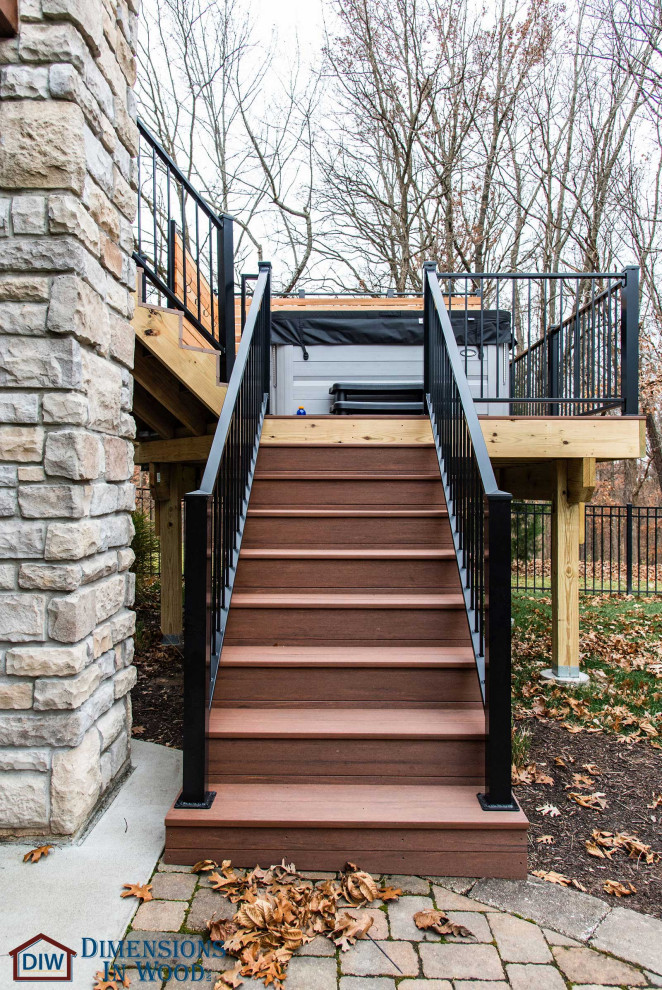 Design ideas for a large modern backyard and ground level deck in Other with metal railing.