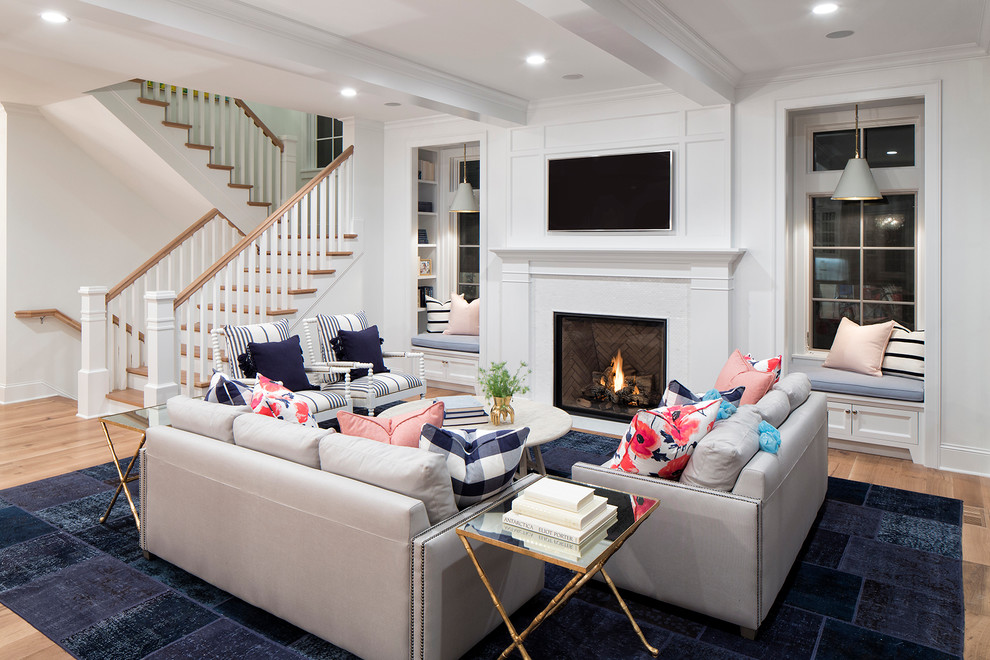Inspiration for a mid-sized traditional open concept family room in Minneapolis with white walls, light hardwood floors, a standard fireplace and a tile fireplace surround.