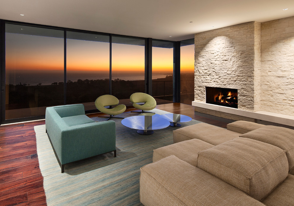Photo of a contemporary open concept living room in Santa Barbara with dark hardwood floors, a standard fireplace and a stone fireplace surround.