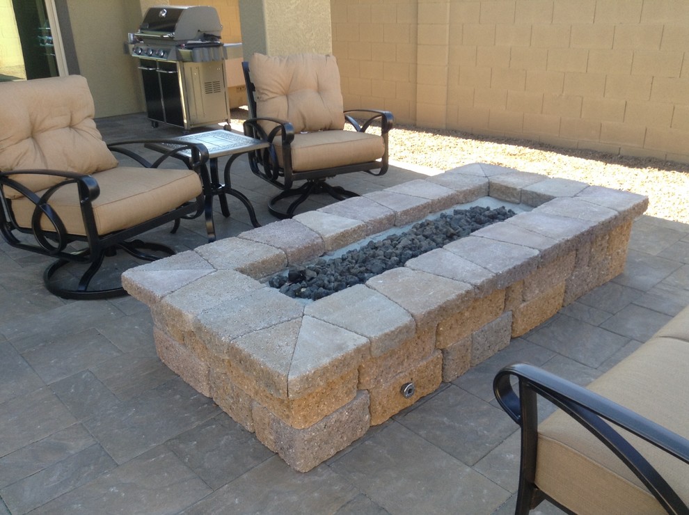 Inspiration for a small country backyard patio in Phoenix with a fire feature.