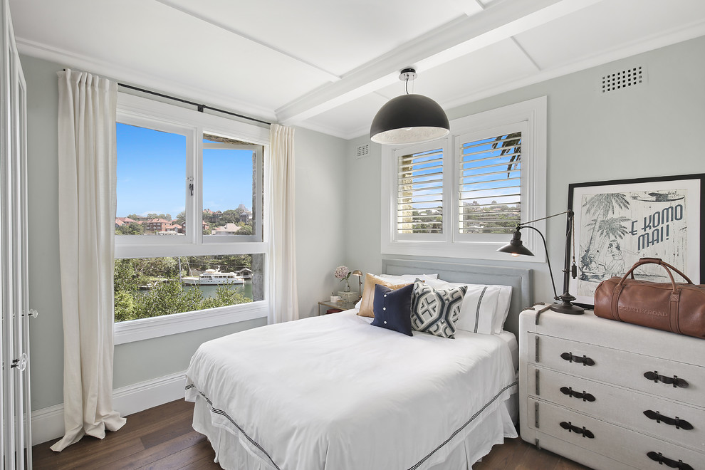 Inspiration for a mid-sized transitional master bedroom in Sydney with dark hardwood floors, brown floor and grey walls.