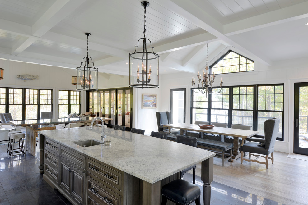 Inspiration for a large transitional porcelain tile eat-in kitchen remodel in Toronto with white walls, a single-bowl sink, raised-panel cabinets, white cabinets, granite countertops, white backsplash, subway tile backsplash, stainless steel appliances and an island