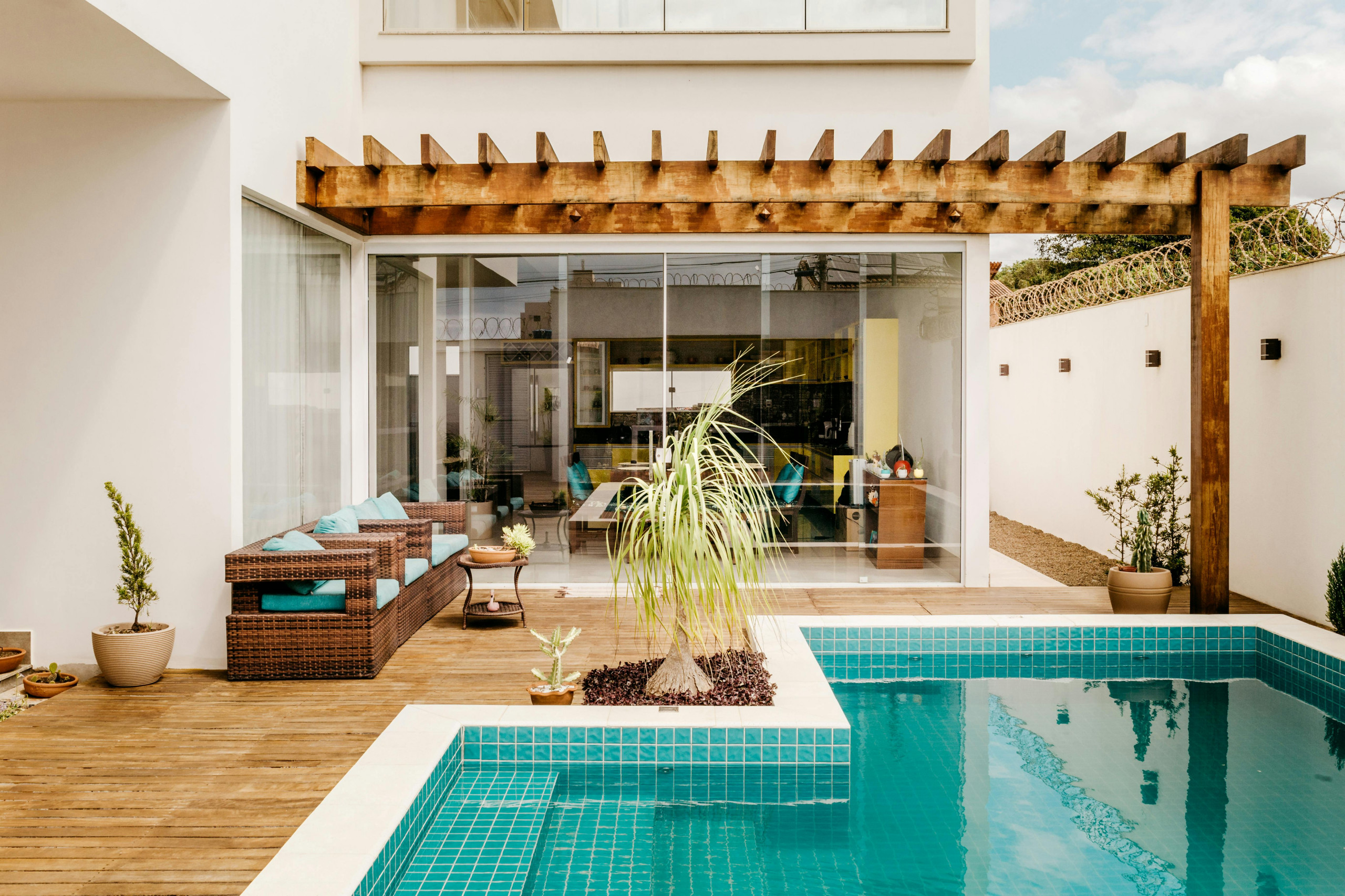 Beautiful pergola, wooden texture gives a refreshing look to  this gorgeous dwelling.